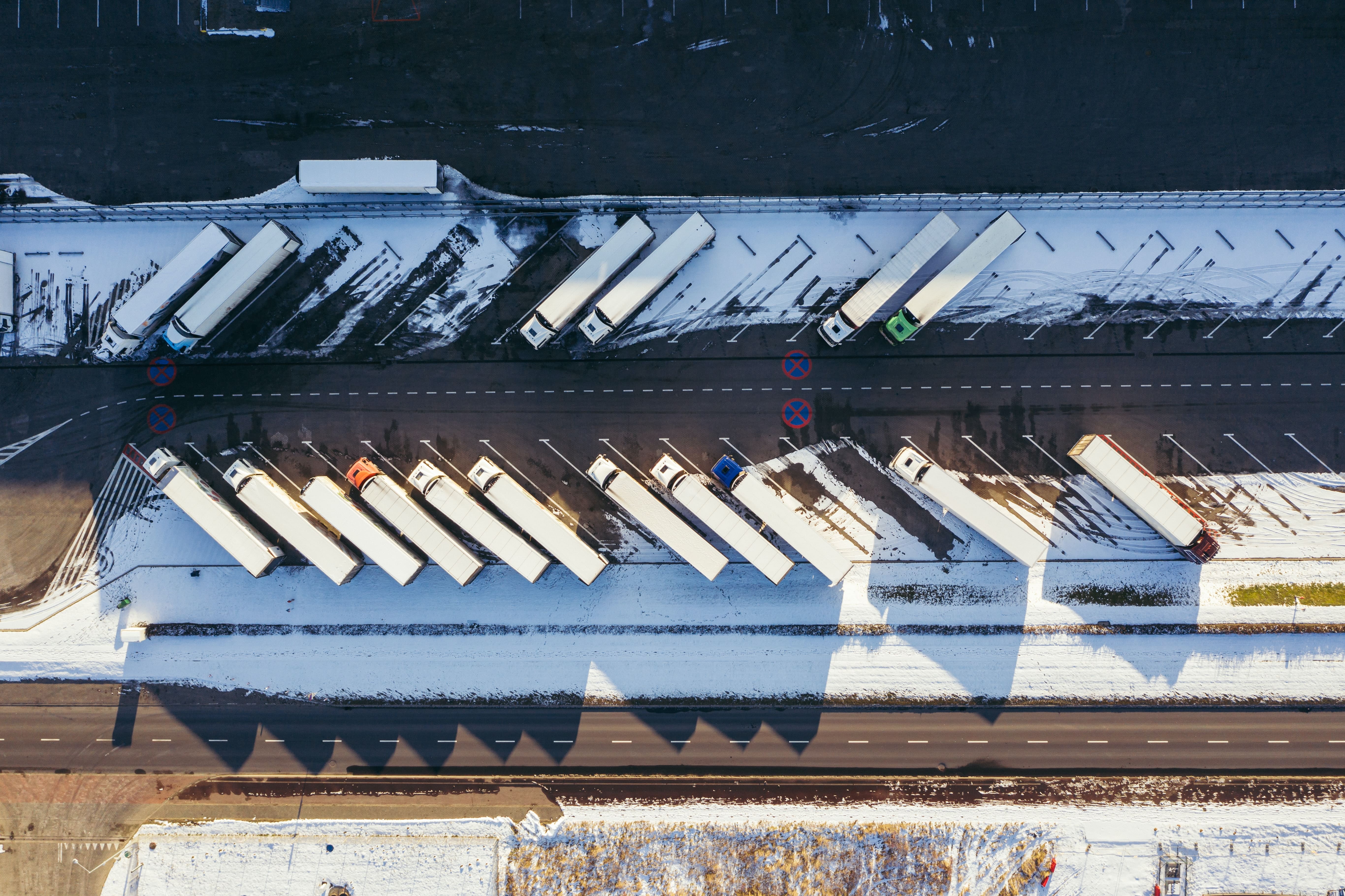 fleet of trucks viewed from top at a truck yard